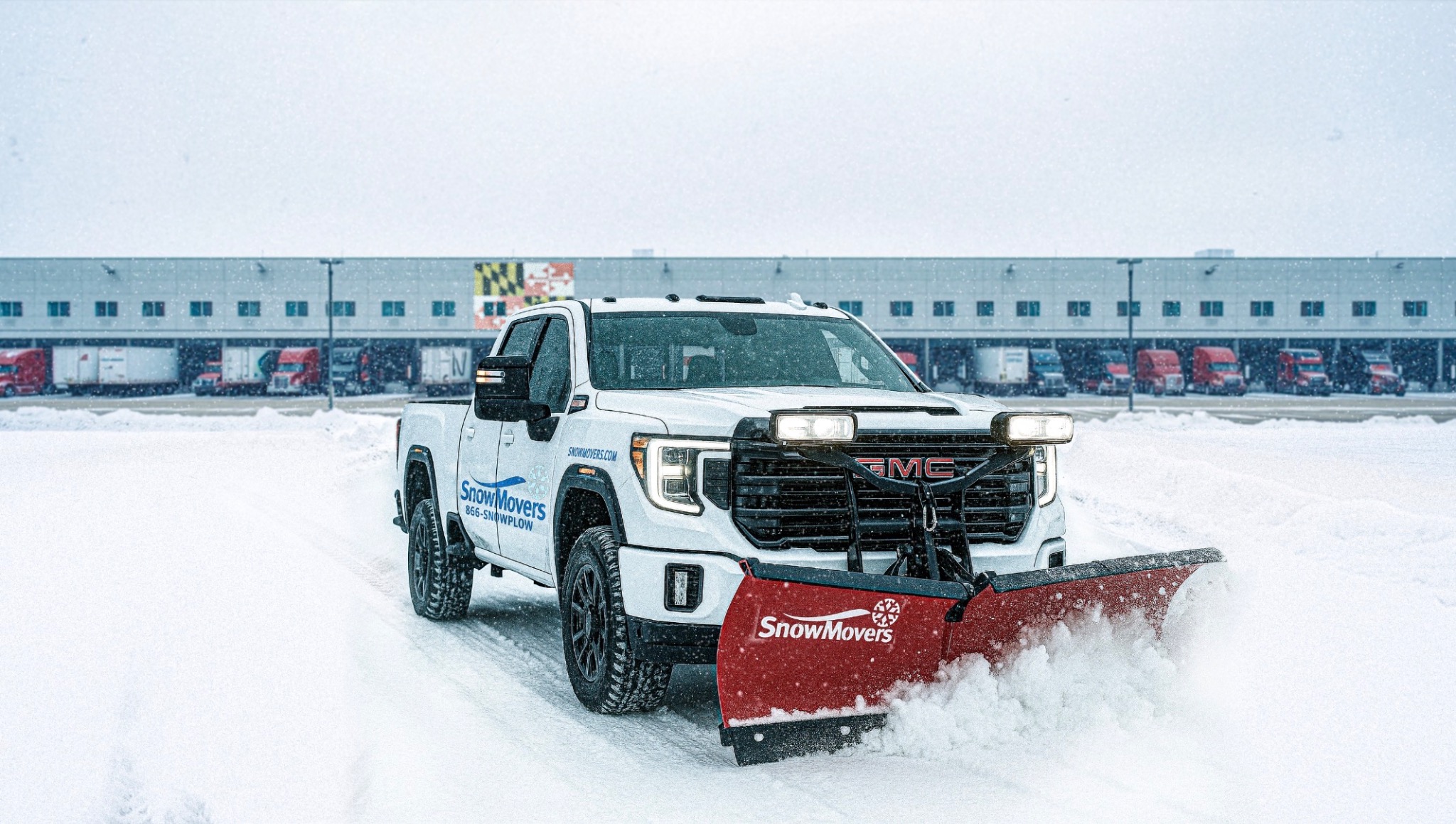 SnowMovers truck clearing snow at a commercial property
